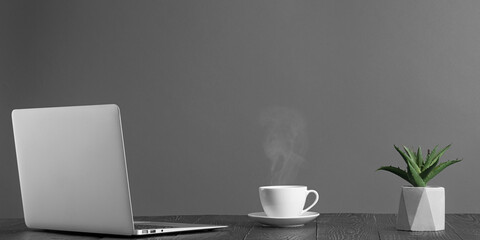 a panorama of desktop with laptop and coffee for advertising