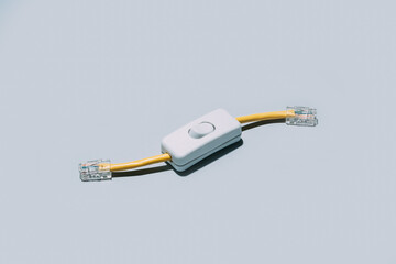 Network cable with switch button isolated on grey background