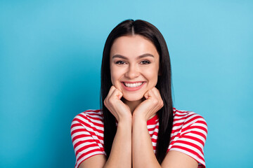Photo of young pretty smiling charming beautiful woman admiring wear red striped t-shirt isolated on blue color background