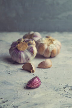 Organic Garlic. Fresh Garlic Cloves and Garlic bulb on  background with Pile of garlic or spice. Selected focus. Concept of spices for healthy cooking.