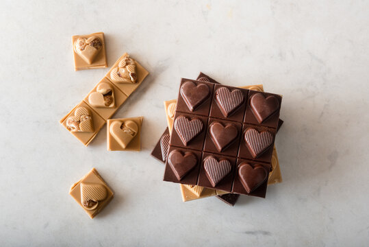 Sweet chocolate candies arranged on white table