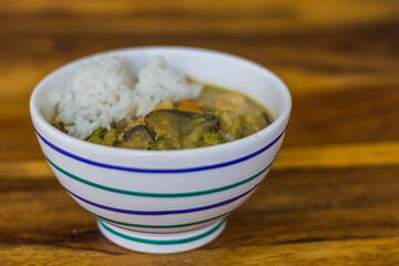 fresh healthy thai green curry and chicken in a bowl on a table