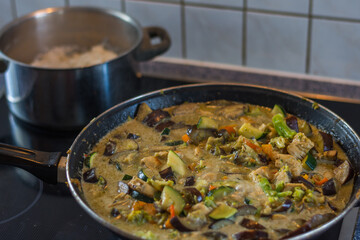 fresh healthy thai green curry and chicken and yasmine rice in a pot