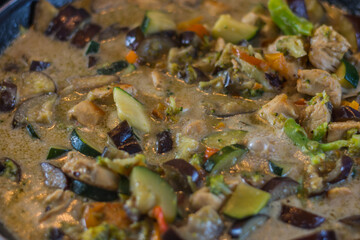 fresh healthy thai green curry and chicken in a pot detail