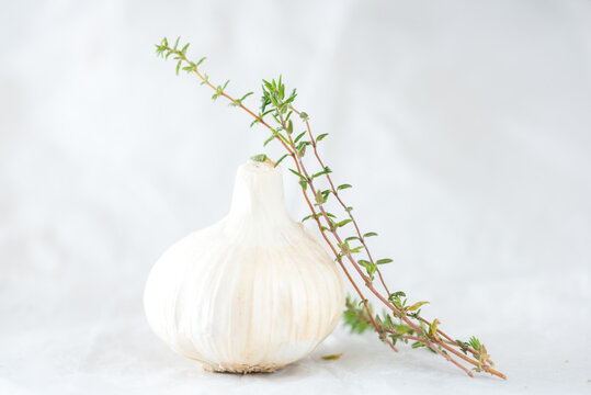 Garlic and herbs placed on table