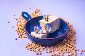 Tofu soy beans and soy milk dairy substitute vegan vegetarian minimalistic copy space negative space pastel purple bacground food style inspiration