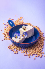 Tofu soy beans and soy milk dairy substitute vegan vegetarian minimalistic copy space negative space pastel purple bacground food style inspiration