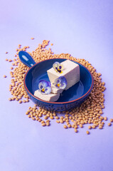 Tofu soy beans and soy milk dairy substitute vegan vegetarian minimalistic copy space negative space pastel purple bacground food style inspiration