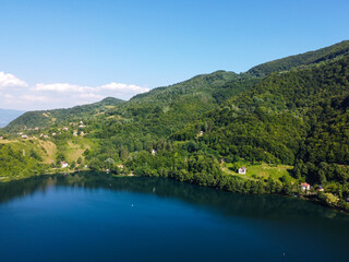Fototapeta na wymiar Aerial drone view of lake surrounded by forest in summer. 
