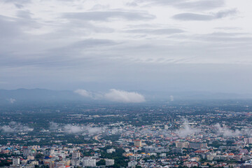 Fototapeta premium Top view of Chiang Mai city scenery Northern Thailand after the rain with fog