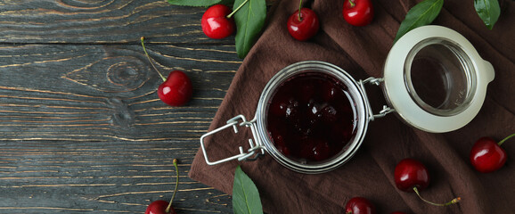 Naklejka na ściany i meble Cherry jam and ingredients on rustic wooden table