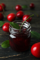 Cherry jam and ingredients on rustic wooden table