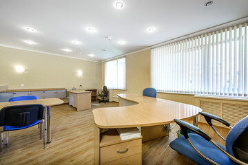 Modern furnished office with office desks and chairs