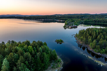Fototapeta na wymiar Evening panorama on Karelian lake Kovdozero. Settlement Zelenoborsky, Kandalaksha, Murmansk region, Kola Peninsula. Polar day. Karelian landscape