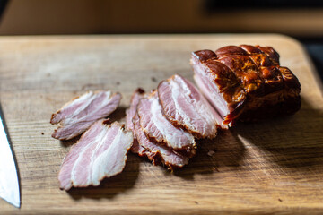 fresh, Polish, smoked bacon, sliced on a kitchen board