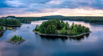 Evening panorama on Karelian lake Kovdozero. Settlement Zelenoborsky, Kandalaksha, Murmansk region, Kola Peninsula. Polar day. Karelian landscape