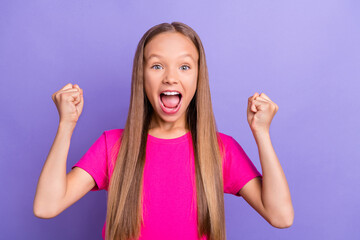 Photo of young happy cheerful crazy small girl winner celebrate fists victory isolated on purple color background