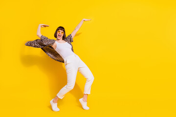 Full length photo of crazy lady dance arm up wear eyewear shirt trousers sneakers isolated on yellow color background