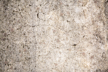 Aged concrete wall with scratches, black points and plaster. Background and wallpaper picture with copy space. Mold and mildew protection concept. Old building part. 