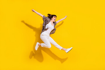 Full length body size view of attractive free cheerful girl jumping having fun great success isolated bright yellow color background