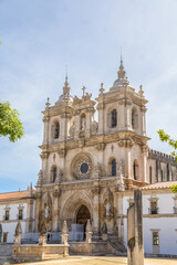 View at the facade of the Alcobaça Monastery (Mosteiro de Santa Maria de Alcobaça), a Catholic monastic complex, the church are Gothic, the towers are Baroque