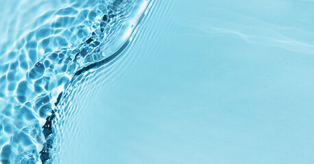 Defocused blue liquid colored clear water surface texture with splashes bubbles with copy space....