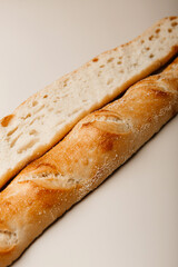 Fresh homebaked delicious baguettes on a white background
