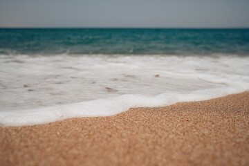 Soft wave of blue ocean on sandy beach. Background. Selective focus                               
