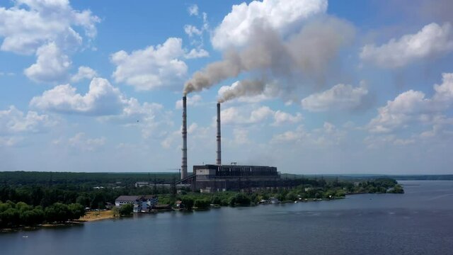 Smoking pipes of factory. Air pollution by smoke coming out of two factory chimneys