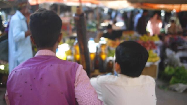 People sitting with flies on them at a market