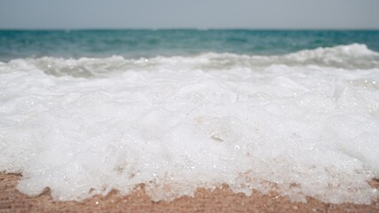 Soft wave of blue ocean on sandy beach. Background. Selective focus                               
