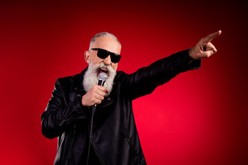 Portrait of attractive cheery popular grey-haired man singing hit having fun resting isolated over...