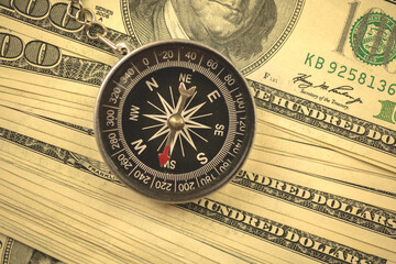 Guessing the dollar rate concept, US currency and compass, busienss background photo