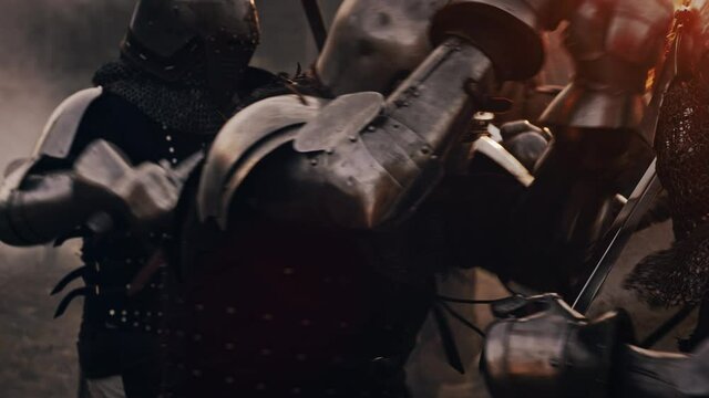 Epic Battlefield: Armies of Medieval Knights Fighting with Swords. Battle of Armed Warrior Soldiers Attacking Enemy. Conflict, War, Conquest, Warfare. Cinematic Historical Reenactment. Slow Motion