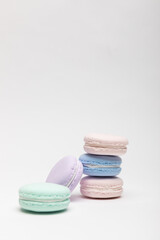 On a table with a white background, there are colorful model macaroons.
