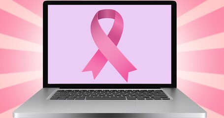 Composition of pink ribbon logo on the laptop screen