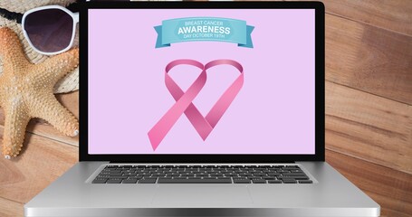 Composition of pink ribbon logo and breast cancer text on the laptop screen