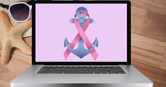 Composition of pink ribbon anchor logo on the laptop screen
