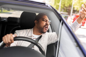 transport, vehicle and people concept - angry indian man or driver driving car and gesturing