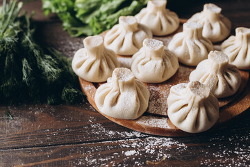 Georgian homemade dumpling or khinkali on cutting wooden board.