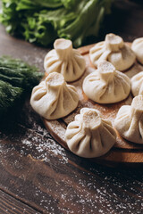 Georgian homemade dumpling or khinkali on cutting wooden board.