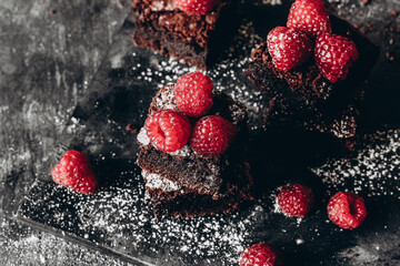 Chocolate Brownie cake with raspberries in a dark style
