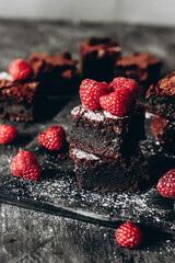 Chocolate Brownie cake with raspberries in a dark style