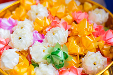 Colorful beautiful handicraft ribbon-flower with coin inside was used to donate or give away to colleague in Thai’s ordination ceremony.