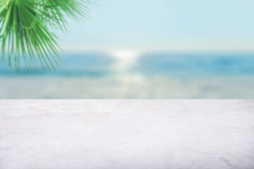 Empty white marble table top with blur sea boekh background. Mockup design for display or montage...