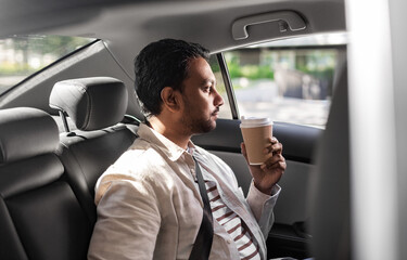 transport, business and people concept - indian man with takeaway coffee on back seat in taxi car