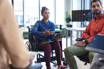 Diverse group of creative colleagues talking at casual meeting