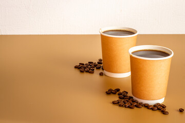 Roasted beans and take away coffee in paper cup