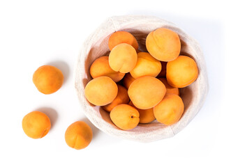 Fototapeta na wymiar Ripe apricots on the table. Orange apricots fruits in a basket. Juicy apricots nutrition. Top View