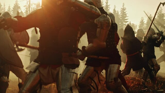 Epic Battlefield: Armies of Medieval Knights Fighting with Swords. Brutal Action Battle of Armored Warrior Soldiers. Dark Ages War, Warfare, Crusade. Cinematic Historical Reenactment. Slow Motion Shot